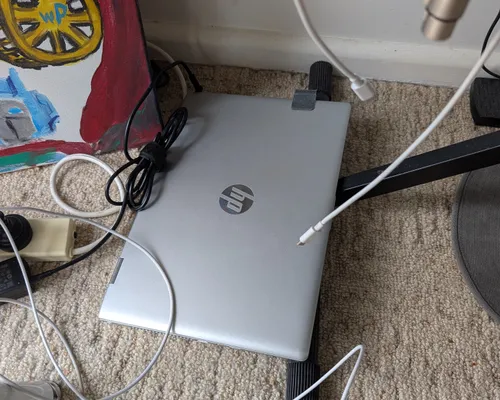 A photo of a laptop in a bedroom